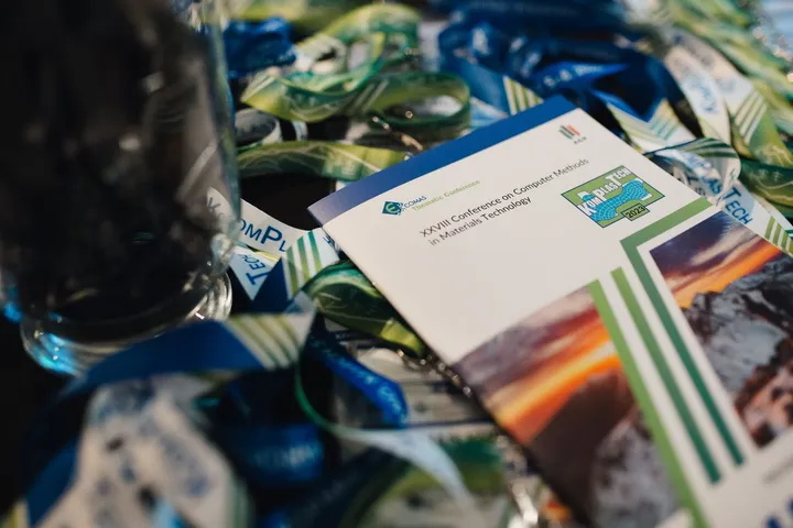 The printed conference programme on a table among lanyards